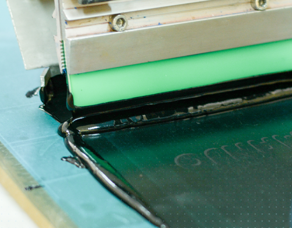 Conductive ink being screen printed with green squeegee